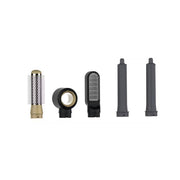 Set of hair styling tools including a comb, clips, and nozzles on a white background