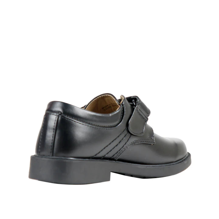 Black leather shoe with a strap on a white background